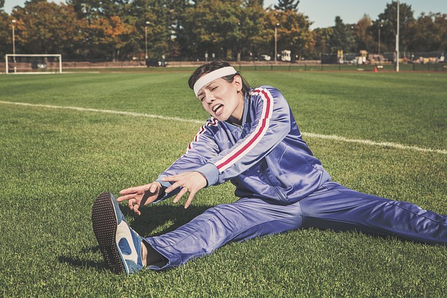 Woman stretching legs on a field before workout