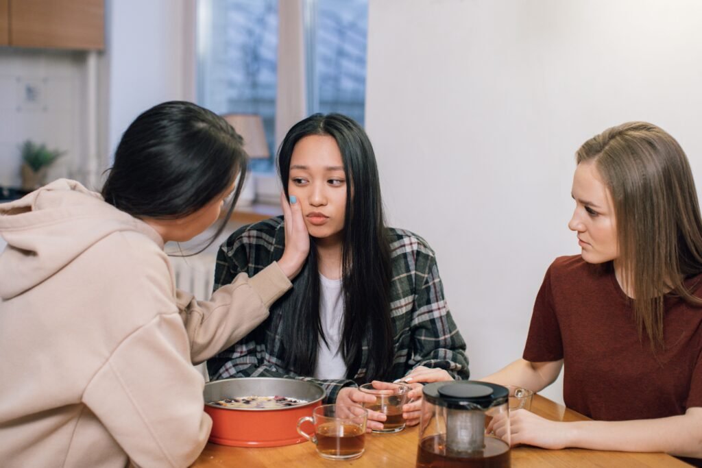 Close friends comforting each other symbolizing quality over quantity in friendships