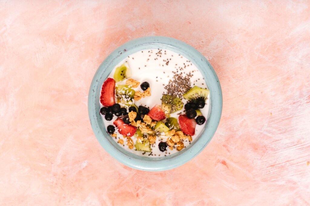 Yogurt bowl topped with fruit and granola, representing fermented foods that support gut health