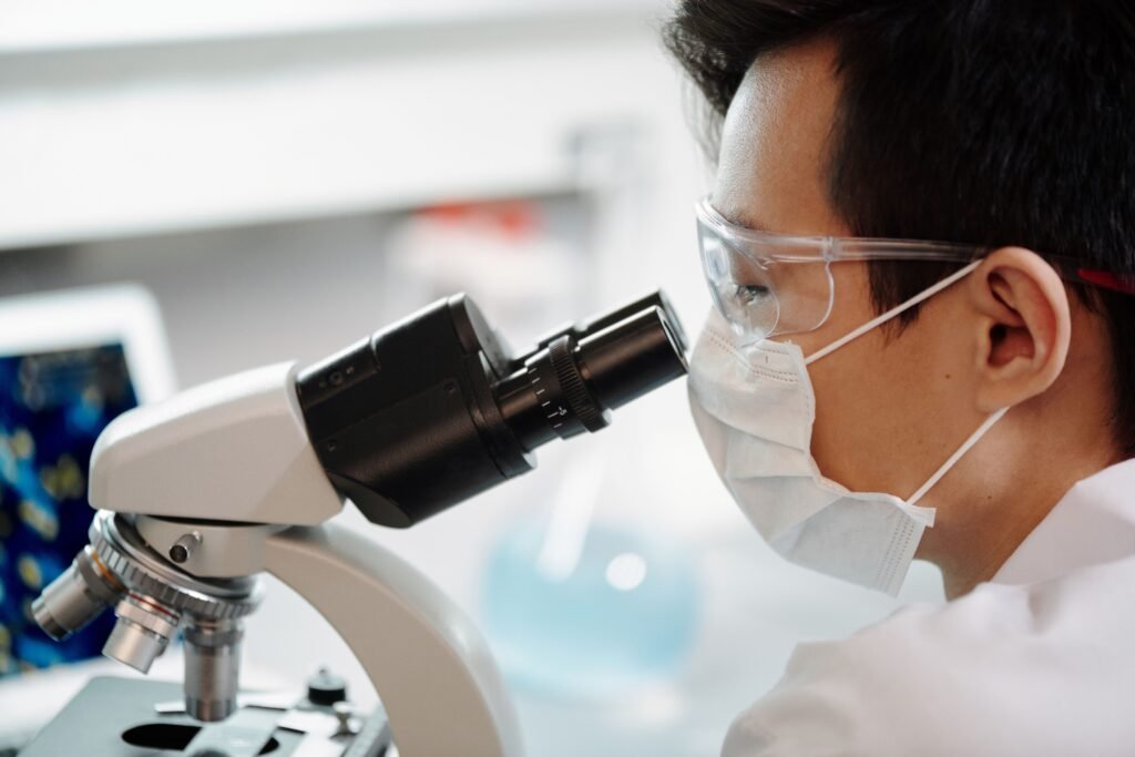 Scientist examining samples under a microscope, illustrating the research behind the gut-brain connection