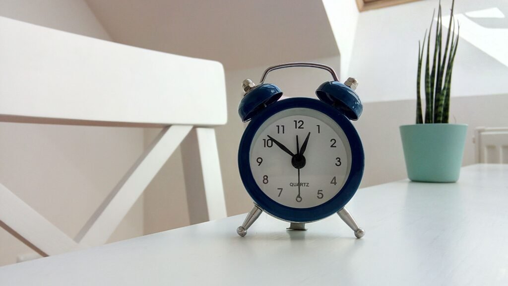 Vintage alarm clock on a table, representing the importance of consistent daily rhythms