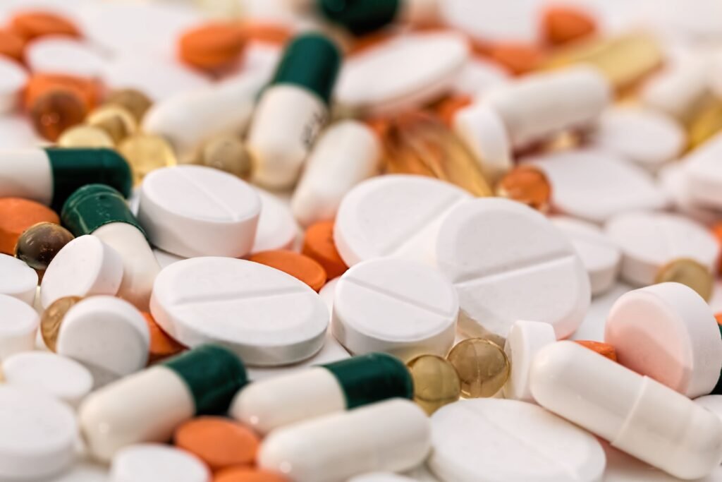 Assortment of colorful pills and supplements, illustrating the myth that longevity requires expensive supplements