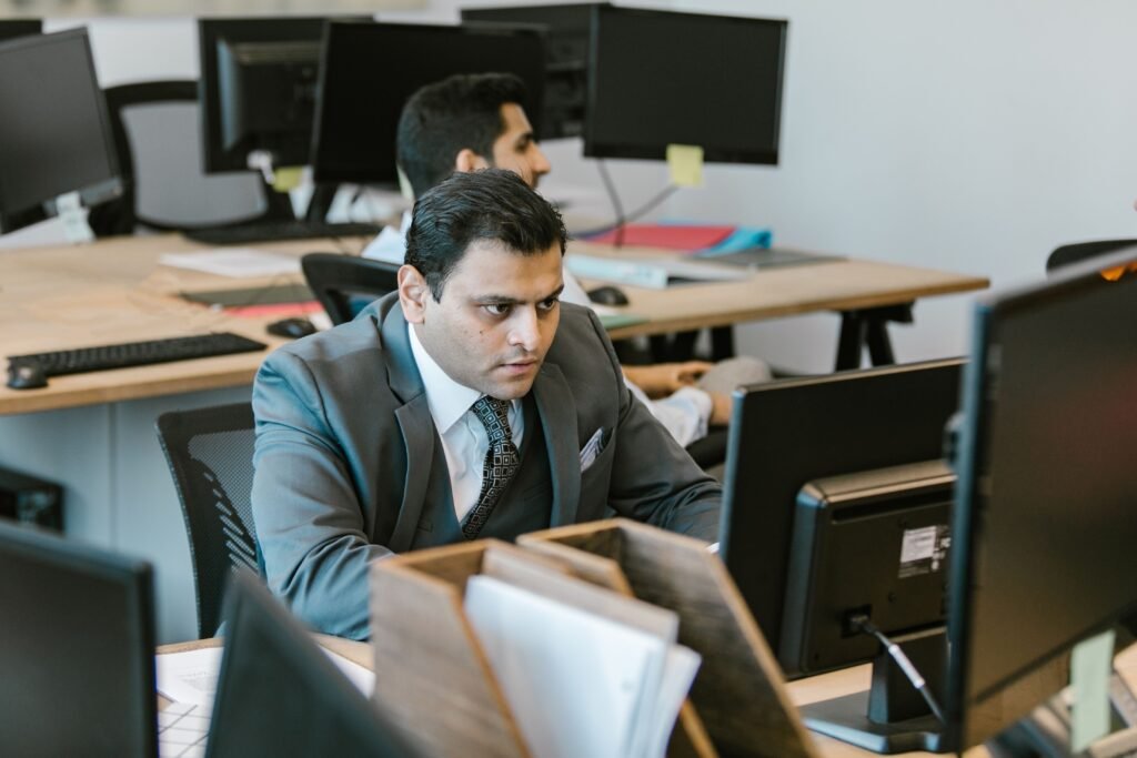 Professional working focused at office desk showing time management success
