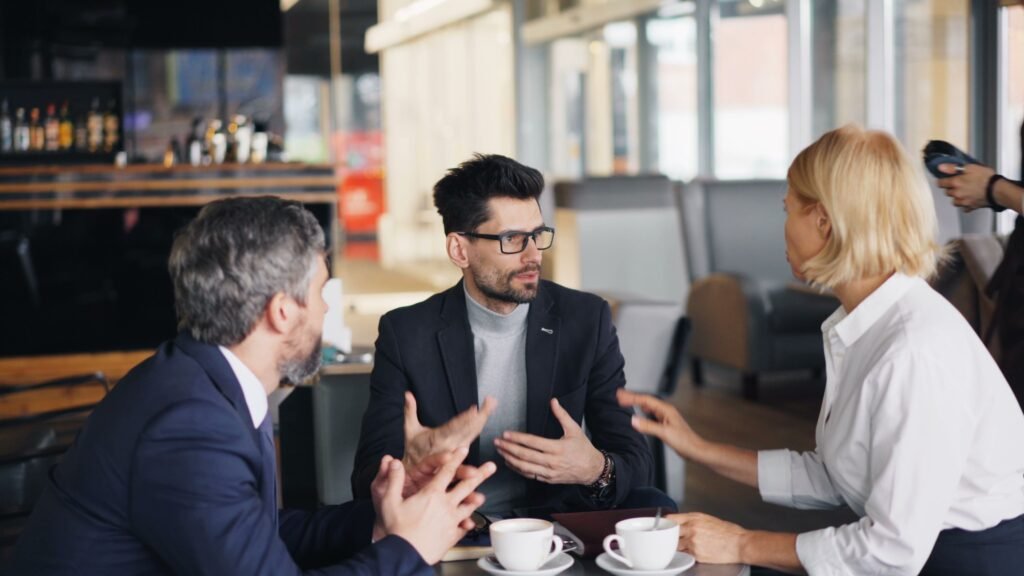 Coworkers talking over coffee symbolizing social health in workplace culture