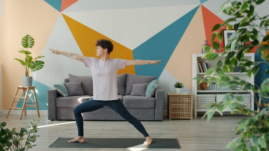Woman doing a yoga pose at home, illustrating how regular movement supports gut health