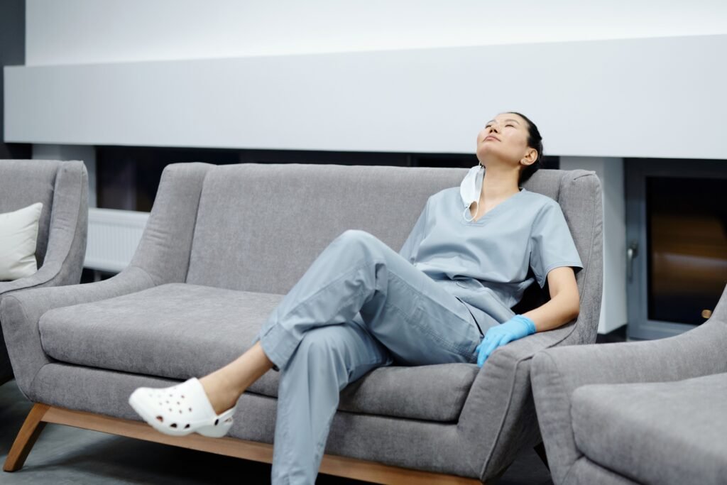Exhausted healthcare worker resting during shift, dealing with sleep deprivation