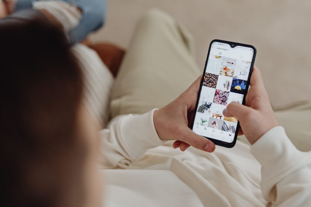 Person scrolling through an Instagram feed on their phone, illustrating why late-night scrolling feels so hard to quit