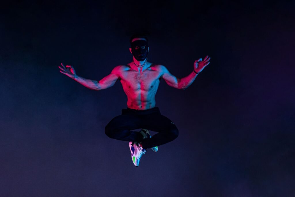 muscular man levitating in a meditative pose, symbolizing physical transformation and peak energy after quitting coffee.