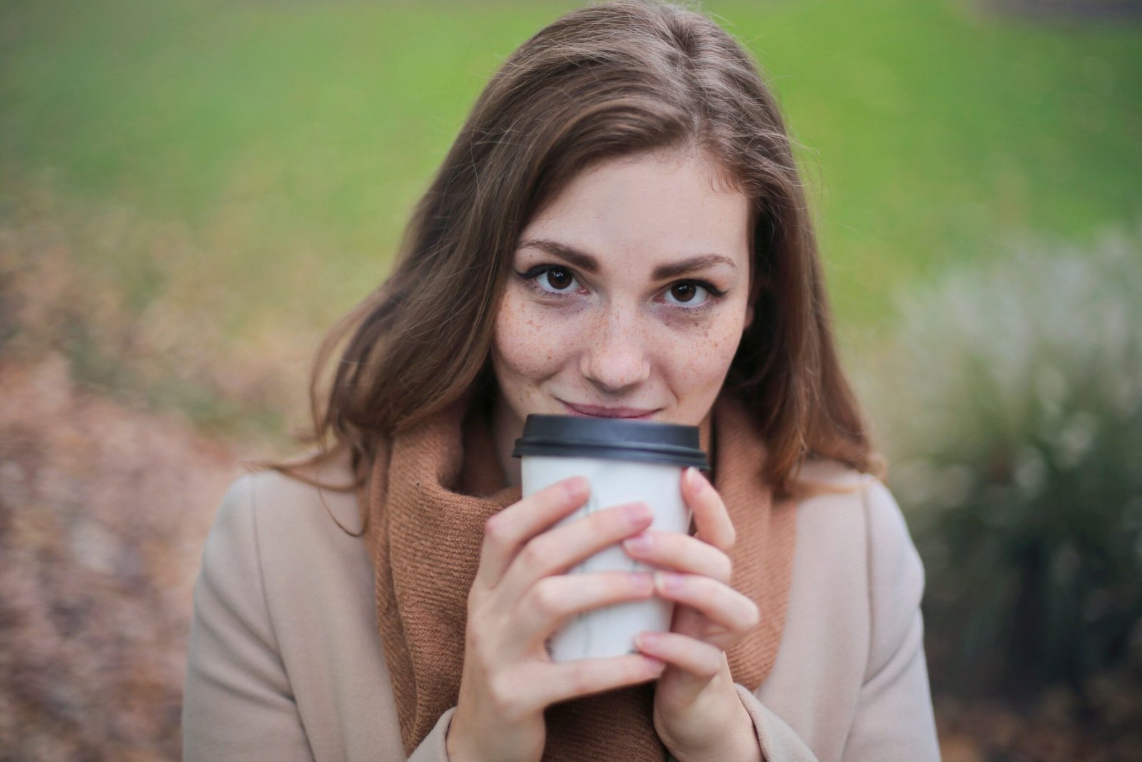 Woman holding a coffee cup, representing the habit before you stop drinking coffee.