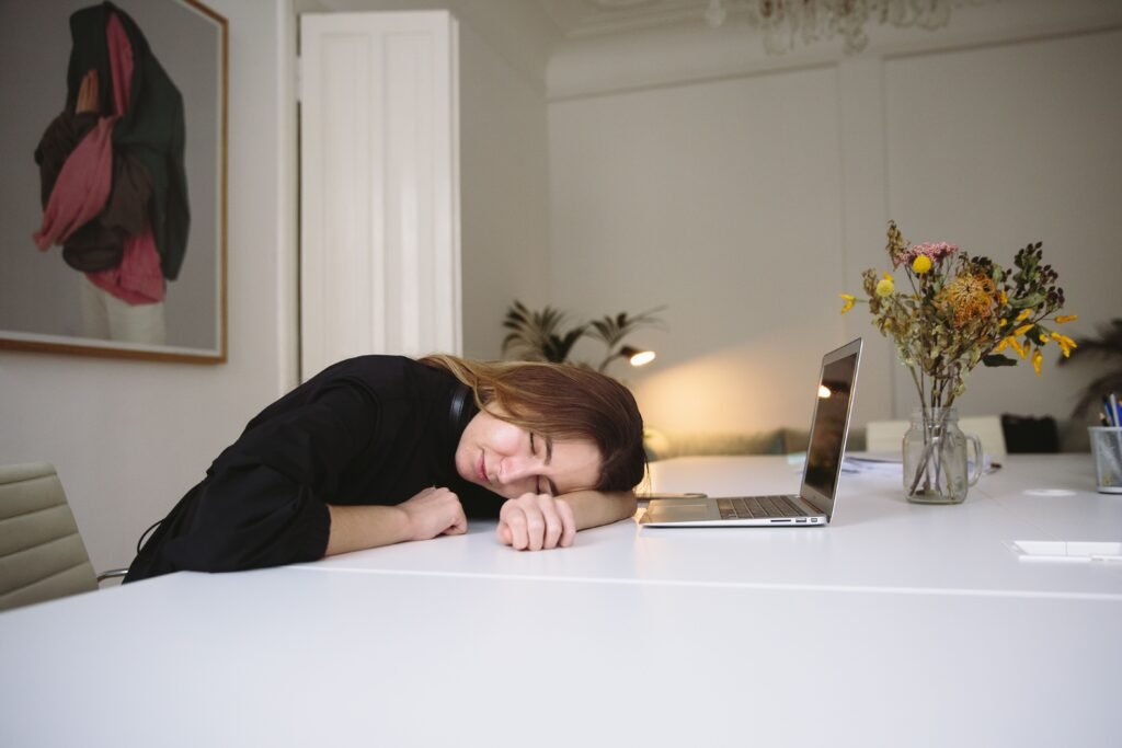 Woman napping at desk to recover memory after sleepless night