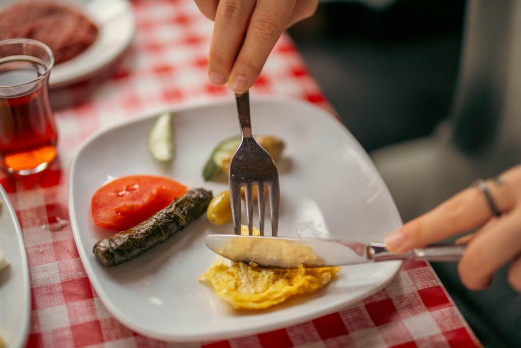 Person enjoying a balanced, moderate meal representing sustainable eating habits